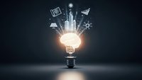 Glowing light bulb with business icons radiating upward representing innovation, creativity and entrepreneurial ideas on dark background.