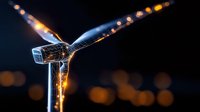 Macro shot of bicycle handlebar with bokeh lights in background creating magical evening atmosphere, shallow depth of field highlights metal surface details.