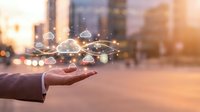 Businessman hand presenting cloud computing network with connected icons floating above palm in urban cityscape background with warm sunlight.