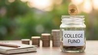Glass jar labeled College Fund filled with coins and bills next to stacked money and graduation cap symbol representing education savings and financial planning.