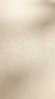Cream colored recycled paper texture with subtle fiber details and natural variations, suitable for backgrounds, packaging design, and print materials.