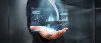 Businessman holding glowing digital financial charts and graphs in palm, representing data analytics, investment growth, and stock market trading technology.