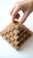 Hand placing wooden block with paw print on pyramid structure representing pet care business growth and animal service development concepts.