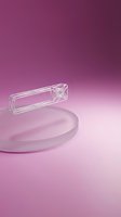 Transparent wireframe geometric shape floating above a frosted glass disc on a pink gradient background, modern minimal concept.