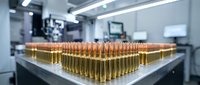 Rows of golden ammunition cartridges arranged on laboratory table in sterile medical or forensic facility for ballistics testing and analysis.