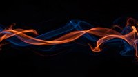 Abstract flowing flames in vibrant blue and orange colors creating dynamic wave patterns against black background for modern design projects.