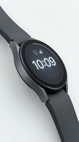 Sleek smartwatch with dark gray silicone band displaying 10:09 on circular AMOLED screen, isolated on white background for product design use.