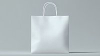 White paper shopping bag with handles on light gray background, mockup for branding and retail design presentation. Clean minimal commercial packaging.