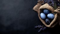 Easter eggs in rustic burlap nest with lavender flowers on dark slate background for spring holiday decorations and greeting cards.