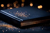 Magical closed book with golden glitter and bokeh lights scattered across dark surface, creating mystical atmosphere for fantasy and storytelling concepts.