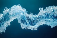 Dynamic water splash frozen in motion against dark blue background creates flowing abstract wave pattern with intricate bubbles and liquid details.