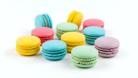 Colorful French macarons in pastel shades isolated on white background. Sweet dessert cookies for bakery menu, cafe advertising and confectionery design.