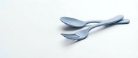 Blue plastic spoon and fork set isolated on white background for eco-friendly dining and food service applications.
