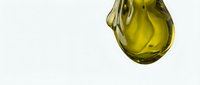 Golden yellow oil droplet suspended against white background, isolated and ready for culinary, cosmetic, and wellness design projects.
