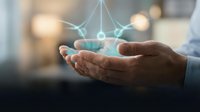 Businessman holding glowing network connection nodes in open palm, representing digital communication, data sharing, and interconnected technology solutions for business growth.
