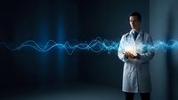 Male doctor in white coat holding glowing energy waves representing medical technology and innovation in healthcare research and digital medicine.