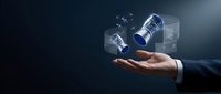 Businessman hand holding glowing holographic jet engine turbines on dark blue background, symbolizing aerospace innovation and technology.