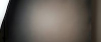 Dark abstract blurred background with soft gradient transition from black to beige, suitable for overlay designs, web backgrounds, and minimalist compositions.