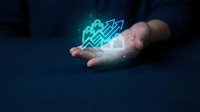 Hands holding glowing holographic shopping bags and growth arrows, symbolizing e-commerce success, retail sales boost, and digital business expansion.
