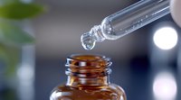 Dropper bottle with liquid medicine drops falling into amber glass container against blurred background, close-up macro photography in soft lighting.