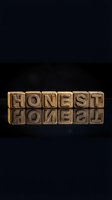 Wooden letter blocks spelling HONEST with reflection on dark surface for typography and business integrity concepts.