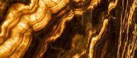 Golden metallic chains with flowing liquid metal texture creating abstract luxury background for premium design projects and artistic compositions.