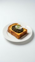 Toasted bread slice topped with black caviar, sour cream, and fresh dill garnish on white plate against neutral background. Luxury appetizer for fine dining and gourmet food concepts.