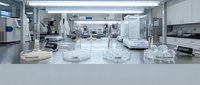 Laboratory petri dishes with bacterial cultures in modern scientific research facility equipped with advanced analytical instruments and sterile workstations for microbiology testing.