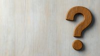 Wooden question mark symbol on light wood background for business concepts, decision making, FAQ sections, and educational materials.