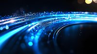 Glowing blue light trails with bokeh effects curve across dark background creating dynamic motion and energy flow for technology and communication designs.