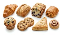 Assorted fresh baked pastries and bread rolls including croissants, muffins, cookies and cinnamon swirls isolated on white background for bakery, cafe and food design projects.