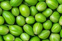 Fresh green gooseberries arranged in rows creating natural pattern background. Ripe summer berries macro photography for food packaging and healthy eating concepts.