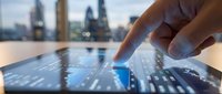 Professional using tablet computer with finger touching screen in modern office with city skyline background for business technology applications.