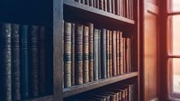 Vintage leather-bound books arranged on wooden library shelves with warm sunlight streaming through window creating atmospheric reading environment.