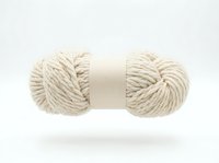 Coiled natural jute twine rope with cream paper band, isolated on white background. Ready for craft projects, packaging design, gift wrapping, and DIY applications.