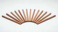 Copper pipes arranged in fan pattern on white background isolated for plumbing heating industrial design projects and technical illustrations.