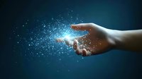 Magical glowing particles floating from an outstretched hand against dark blue background, creating ethereal light effect for fantasy and spiritual concepts.