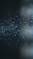 Abstract dark background with floating water droplets and bokeh light effects creating dreamy atmospheric mood for digital design projects.