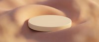 White round podium or platform on soft beige sand with warm lighting, suitable for product display, cosmetics showcase, or luxury brand presentation.