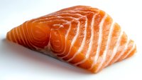 Fresh raw salmon fillet with distinctive orange flesh and white striped pattern on white background, showcasing natural marbling texture for culinary and food photography.