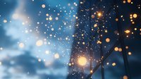 Magical winter evening with glowing bokeh lights and snowflakes against dark blue sky, creating dreamy atmospheric backdrop for seasonal designs.