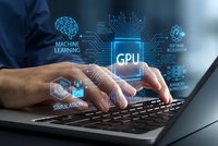 Professional man typing on laptop with holographic GPU processor and machine learning technology interface overlay for computing and AI development.