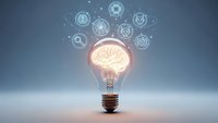 Light bulb with glowing brain inside surrounded by floating technology icons representing innovation, creativity and digital transformation concepts.