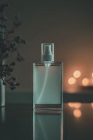 Elegant glass perfume bottle on reflective surface with soft bokeh lights and plant silhouette in moody atmospheric setting, luxury cosmetic product photography.