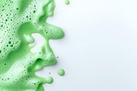 Abstract green liquid soap foam and bubbles on white background creating organic flowing shapes and dynamic texture for cosmetic designs.