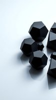 Black geometric dodecahedron shapes casting shadows on white surface creating modern minimalist composition for contemporary design projects.