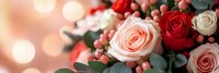 Elegant rose bouquet with red and pink blooms, berries and eucalyptus leaves on soft bokeh background for romantic occasions and floral arrangements.