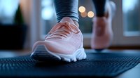 Pink athletic sneaker close-up on exercise mat with bokeh lights in background. Fitness and workout concept showing active lifestyle and sports equipment.
