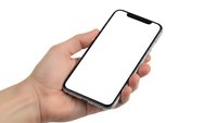 Hand holding modern smartphone with blank white screen isolated on white background for mobile app mockup and digital technology presentation.
