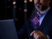 Middle-aged Asian businessman in dark suit working on laptop with glowing purple digital transformation visualization emerging from screen in dark office.